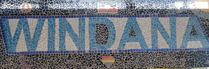 A mosaic spelling out the word "Windana" in blue tiles against white.