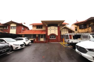 A large old building with cars parked outside it